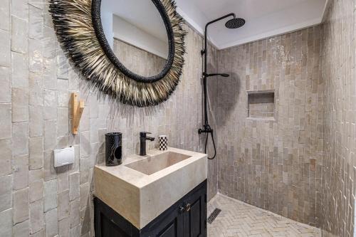 a bathroom with a sink and a mirror at Riad Kamil 4Suites - Private Pool - Rooftop Lounge in Marrakesh