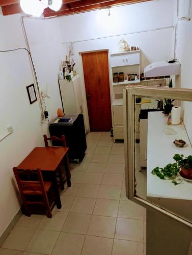 a small kitchen with a table and a table and a table and a tableablish at Mi casa, Su casa in Salta