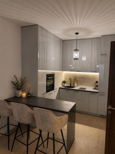 a kitchen with a table and some chairs in it at Adriatic Escape in Radanovići