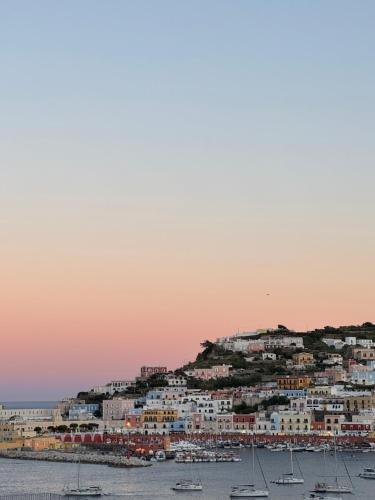 a town on a hill with boats in the water at B&B Ponza Suite in Ponza