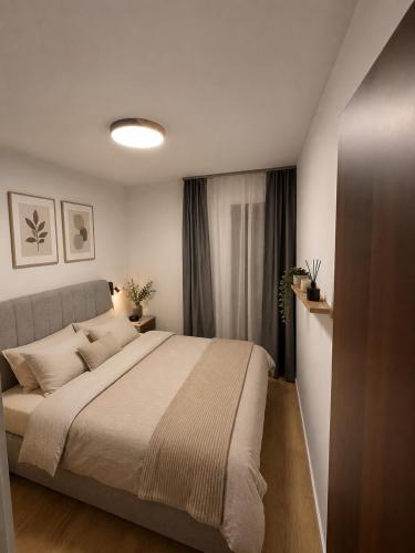 a bedroom with a large bed and a window at Adriatic Escape in Radanovići