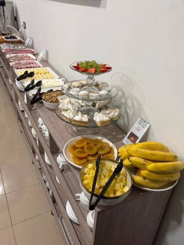 a buffet with bananas and other food on a table at Hotel Frontera in Antofagasta