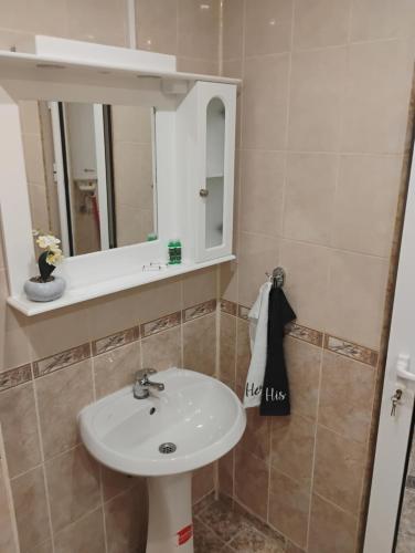 a bathroom with a sink and a mirror at STADIUM 1 Apartments Sandanski in Sandanski