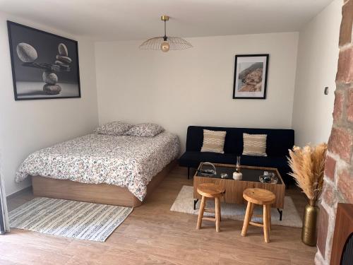 a bedroom with a bed and a table and a couch at Large studio in Obernai in Obernai