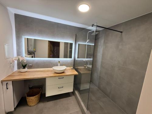 a bathroom with a sink and a shower at Peaceful haven in Liepāja
