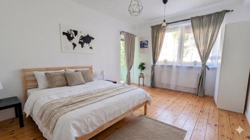 a bedroom with a large bed and a large window at G-8HOSTEL Gdynia in Gdynia