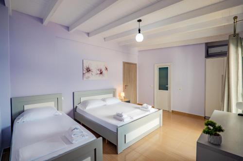 a bedroom with two beds and a table at Blue Stay Boutique Hotel in Himare