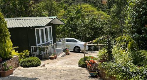 a car parked next to a shed with a car at Krupitskiy House in Chakvi