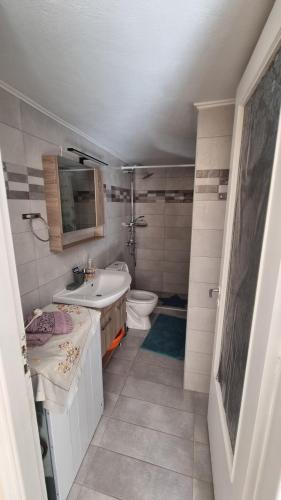 a bathroom with a sink and a toilet at Venetia' s house in Kalamata