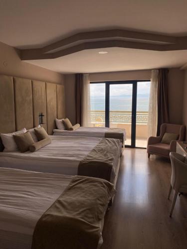 a hotel room with two beds and a large window at Mirage Hotel & SPA - Struga in Struga