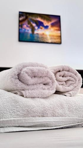 a pile of towels sitting on top of a bed at Vila Llaka in Himare