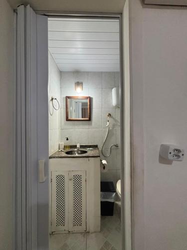 a bathroom with a sink and a mirror at Aura House Búzios in Búzios