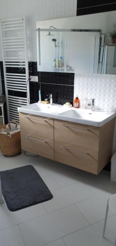 a bathroom with a sink and a mirror at La maison dans les vignes in Châteauneuf-sur-Charente