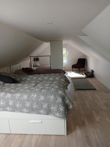 a bedroom with a large bed in a attic at Önnestad guest house in Önnestad