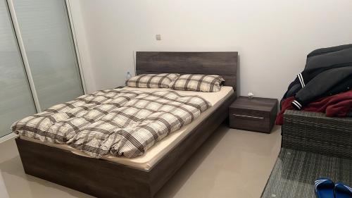 a bedroom with a large bed with a wooden headboard at Marina Golf 7 in Asilah