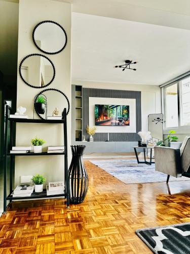 a living room with a vase on a wooden floor at Home By The Sea in Gqeberha