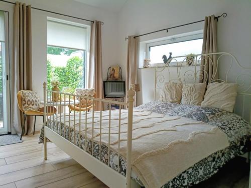a bedroom with a metal bed and a window at The Two Branches in 't Waal