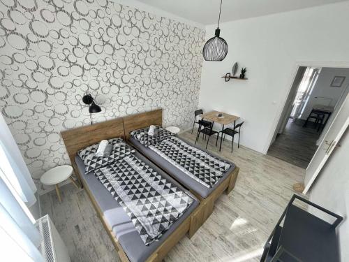 a large bed in a room with a table and chairs at Víkend Apartmanok in Révfülöp