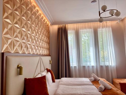a bedroom with a bed and a window at Annie Villa in Siófok