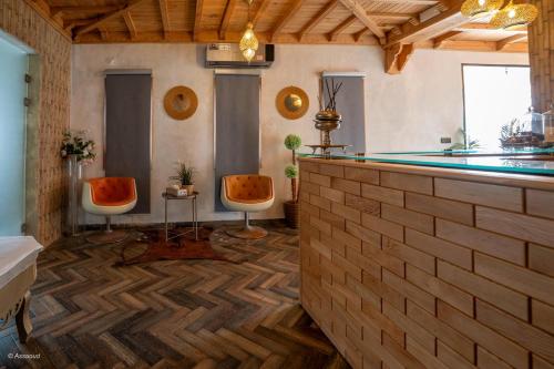a pool room with two chairs and a pool table at Resort Hotel El Cortijo & Spa in Chefchaouen
