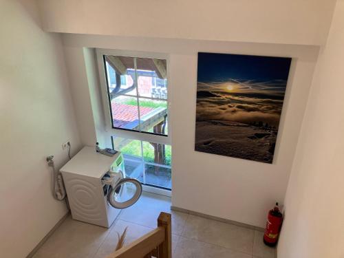 a bathroom with a washing machine and a window at Ferienwohnung Eble bei Markt Rettenbach in Markt Rettenbach