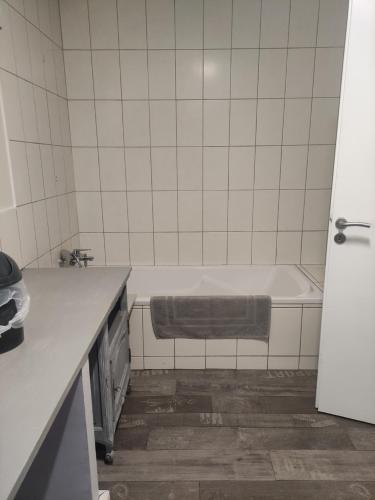 a bathroom with a bath tub in a kitchen at Chez So et Compagnie in Saint-Gérand-de-Vaux