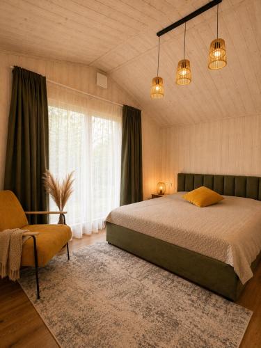 a bedroom with a bed and a large window at Escape to Nature - Piparmētras in Mērsrags