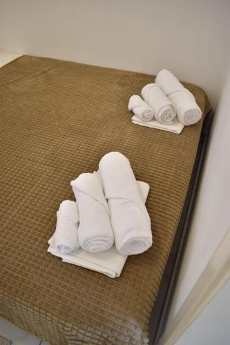 three rolls of white towels on a shelf at Kuća za odmor Nada in Marina