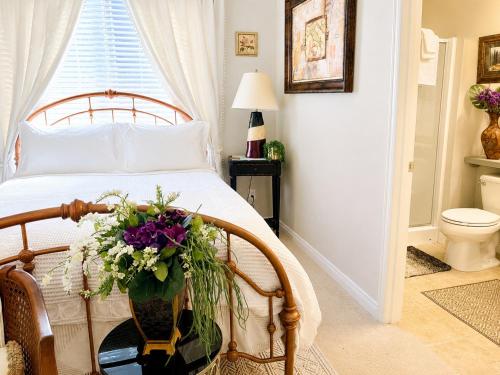 a bedroom with a bed with flowers on a table at The Elegant & Cozy Retreat in Sammamish