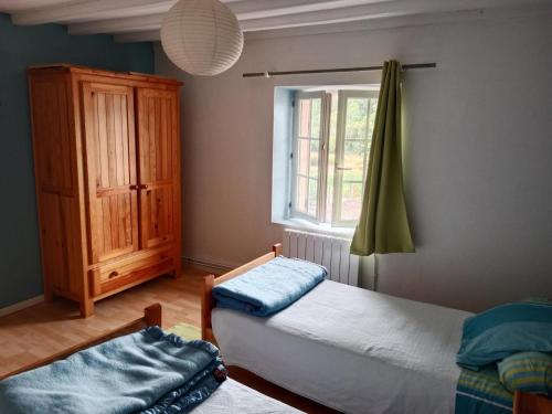 a bedroom with two beds and a window at La petite lisonne in Marval