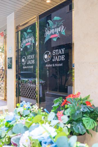 a store front with plants in front of a window at Stay JADE in Seoul