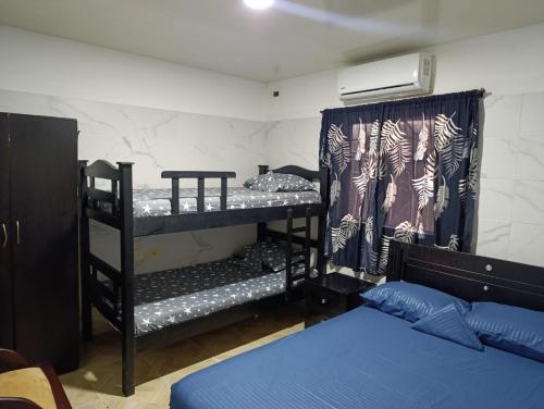 a room with two bunk beds and a bed at APARTAMENTOS LIZ MARIA in Coveñas