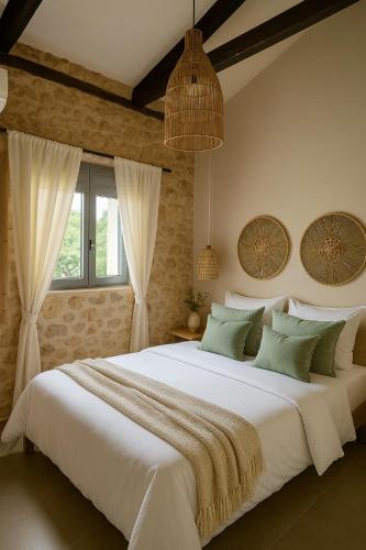 a large white bed in a room with a window at ArKa in Chania