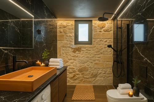 a bathroom with a wooden sink and a shower at ArKa in Chania