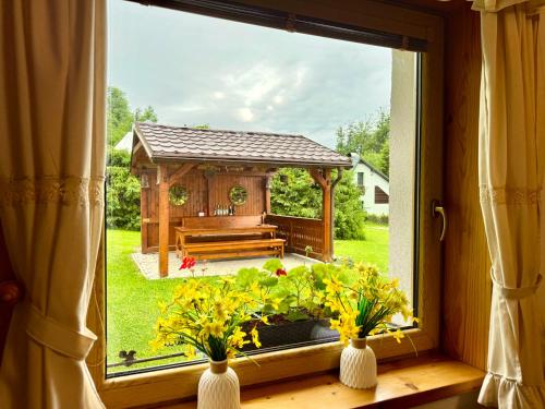 a window with a view of a gazebo at Chata na Zbojskej - Zbojská in Pohronská Polhora