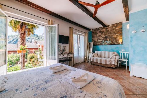 a bedroom with a bed and a large window at B&B Il Feriolo in Baveno