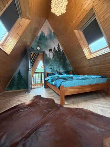 a bedroom with two beds in a attic at Cabana Vlad Tepes in Arefu