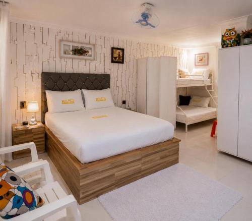 a bedroom with a bed and a chair in it at Hotel1325 in Baní