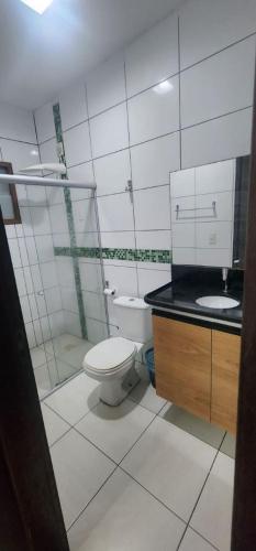 a bathroom with a toilet and a sink at Casa confortável para o são joão in Campina Grande