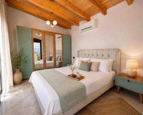 a bedroom with a large bed and a window at Meis Villas in Dhërmi