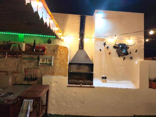 a kitchen with a stove on the wall at La Terraza del Castillo- Playa de Rota in Rota