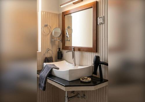 a bathroom with a sink and a mirror at Sunshine Resort & Spa Sigiriya in Sigiriya