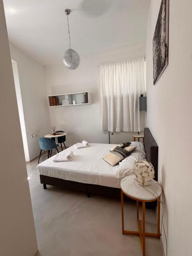 a bedroom with a bed and two tables in it at Villa Martina Luxury Suites Como Lake in Lecco