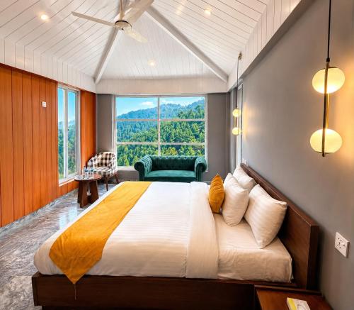 a bedroom with a large bed and a large window at Grand Montis Hotel in Abbottabad