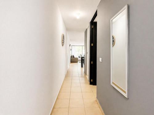 a hallway with white walls and a mirror on a wall at Loft Sipeh Xalapa Departamento 4 in Xalapa