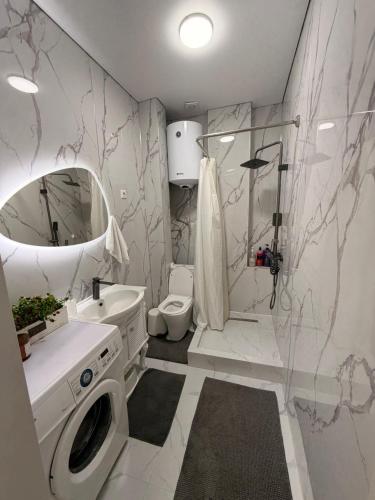 a bathroom with a sink and a washing machine at Nomad Resort Cholpon-Ata in Cholpon-Ata