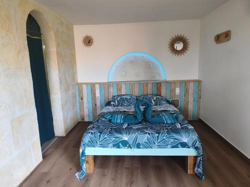 a bedroom with a bed with a wooden head board at Ti Colibri in Deshaies