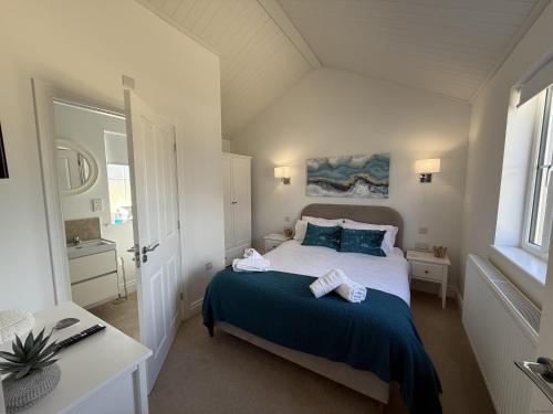 a bedroom with a bed with two towels on it at The Lake House, The Bay Filey, sleeps 4 in 2 double rooms with ensuites, 1 dog welcome in Filey