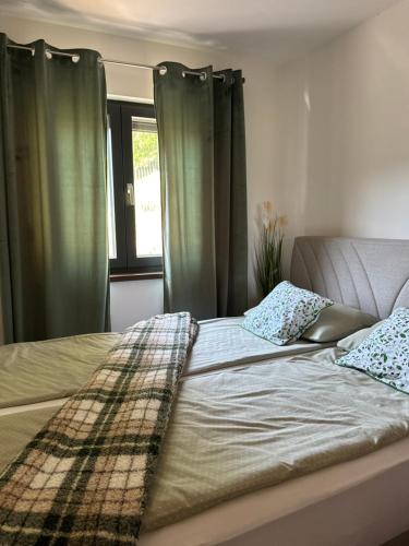 a bed with two pillows on it in a bedroom at Vila Kraljica Une in Bosanska Krupa