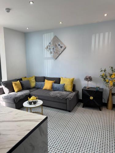 a living room with a couch and a table at Dove & Gold in Gloucestershire